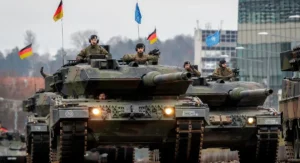 Німецькі танки Leopard на параді під прапорами Німеччини та НАТО