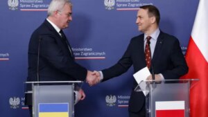 Радослав Сікорський тисне руку українському дипломату під час зустрічі в Польщі